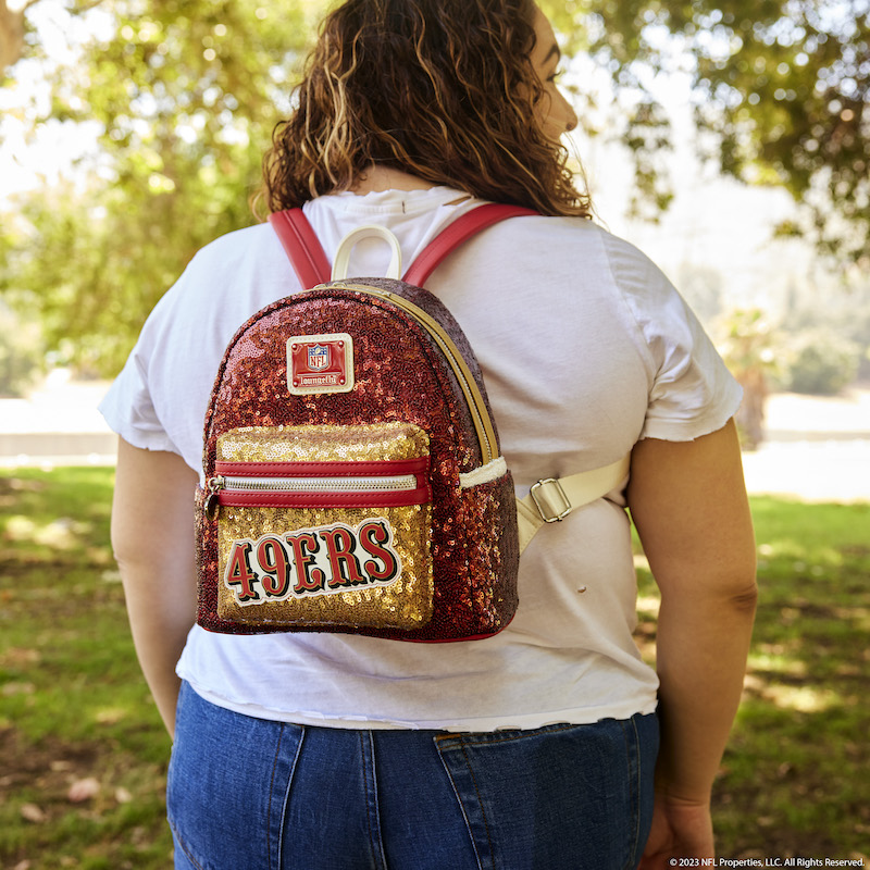 Image of woman facing away from camera wearing the NFL San Francisco 49ers Sequin Mini Backpack 